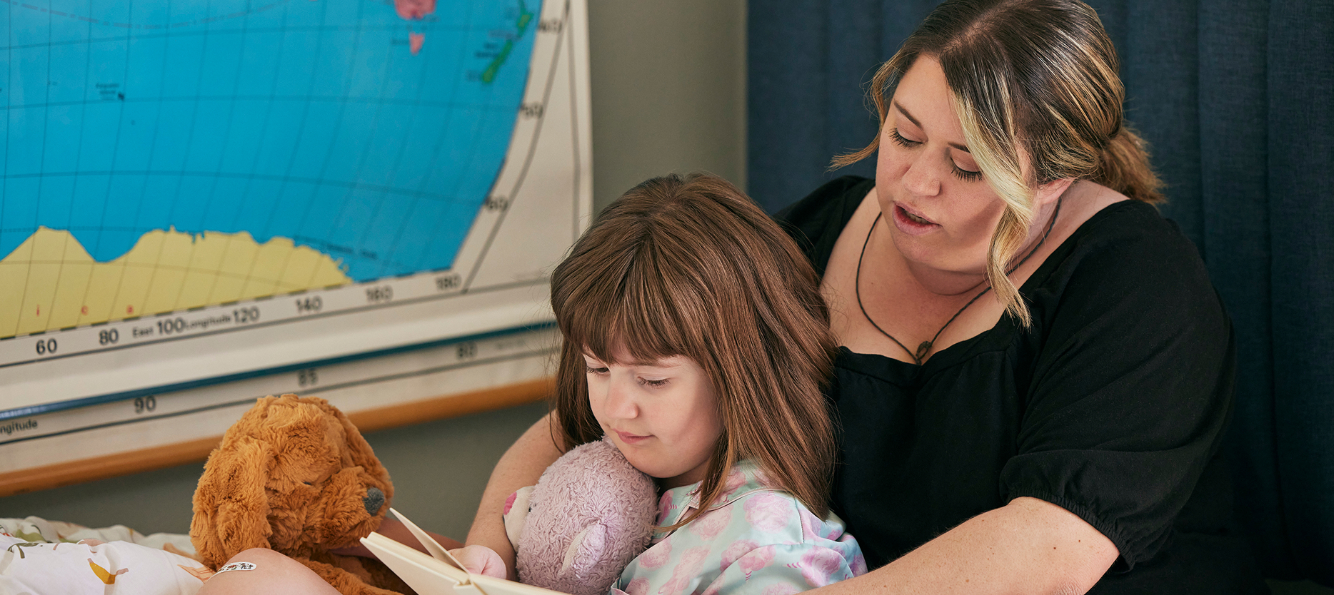 JazzCares for EPIDIOLEX | Child and caregiver sitting with a book